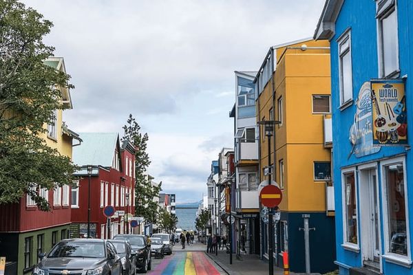 a colorful street with a rainbow painted on the side of it in a city in Iceland, Reykjavík.