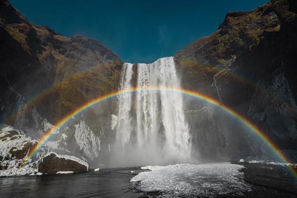 rainbow in front of a waterfall