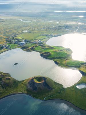 an aerial view of a lake surrounded by volcanoes in iceland .