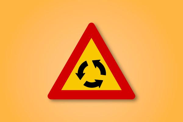 a yellow and red triangle sign with two arrows pointing in opposite directions on an orange background .