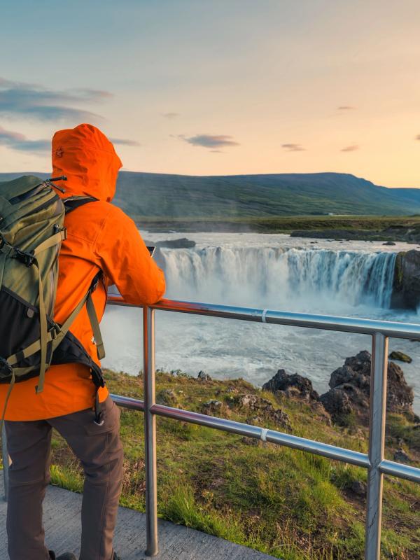 Tourist admiring Godafoss waterfall
