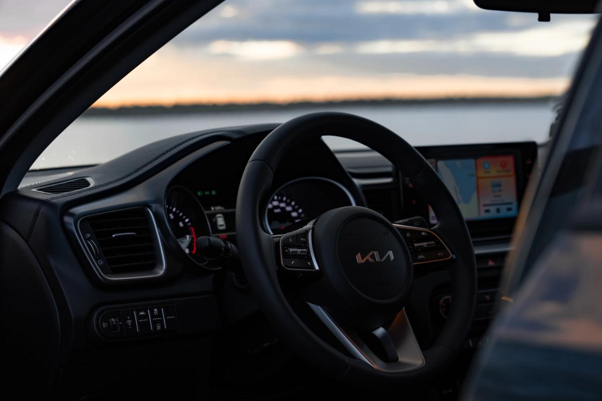 Kia Ceed steering wheel and dashboard viewed through open driver door