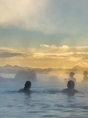 a group of people are swimming in Sky Lagoon