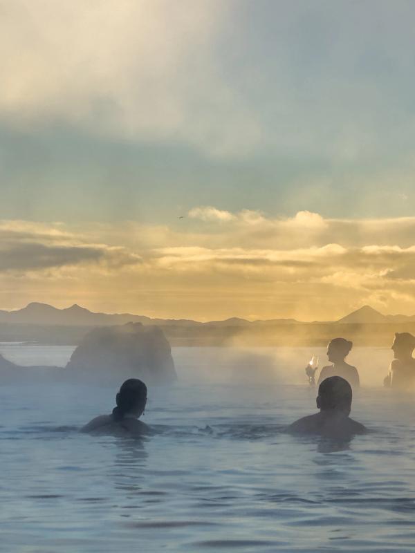 a group of people are swimming in Sky Lagoon
