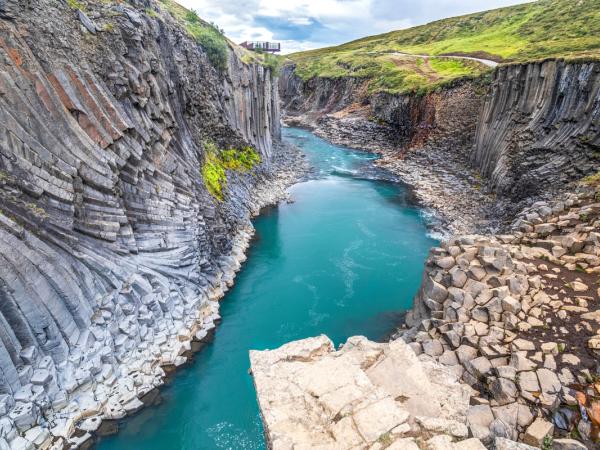 a river flowing through a narrow canyon surrounded by rocks .