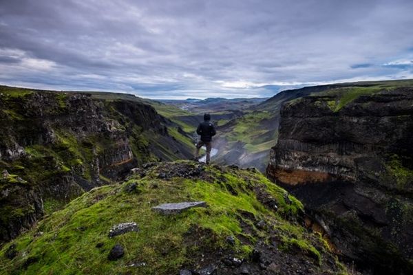Hombre en un acantilado mirando al horizonte