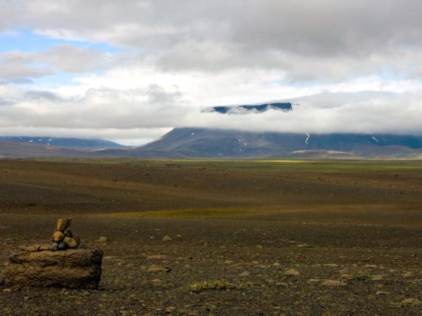 a pile of rocks sitting on top of a rock in the middle of a desert .