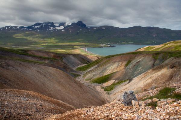 a valley with mountains in the background and a lake in the middle .