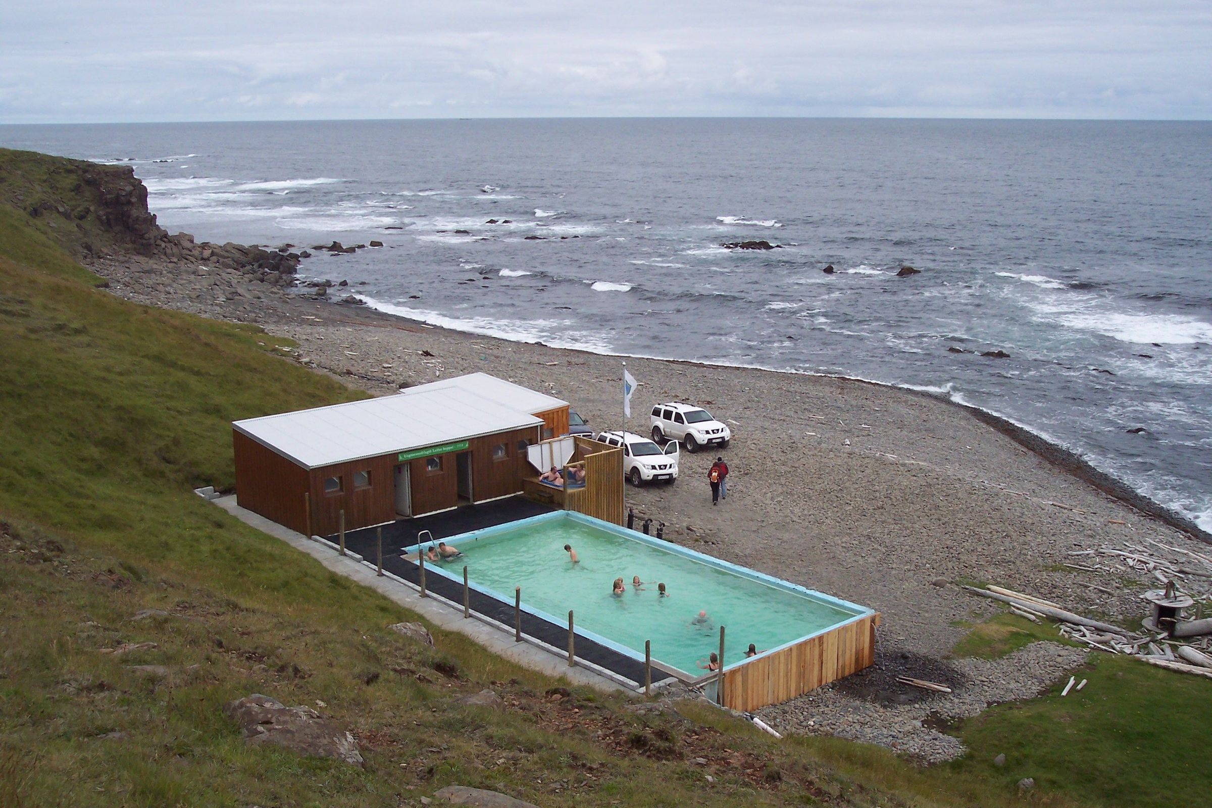 Krossneslaug a view from above of Krossneslaug hot spring in iceland, showing changing rooms with showers for the geothermal pool
