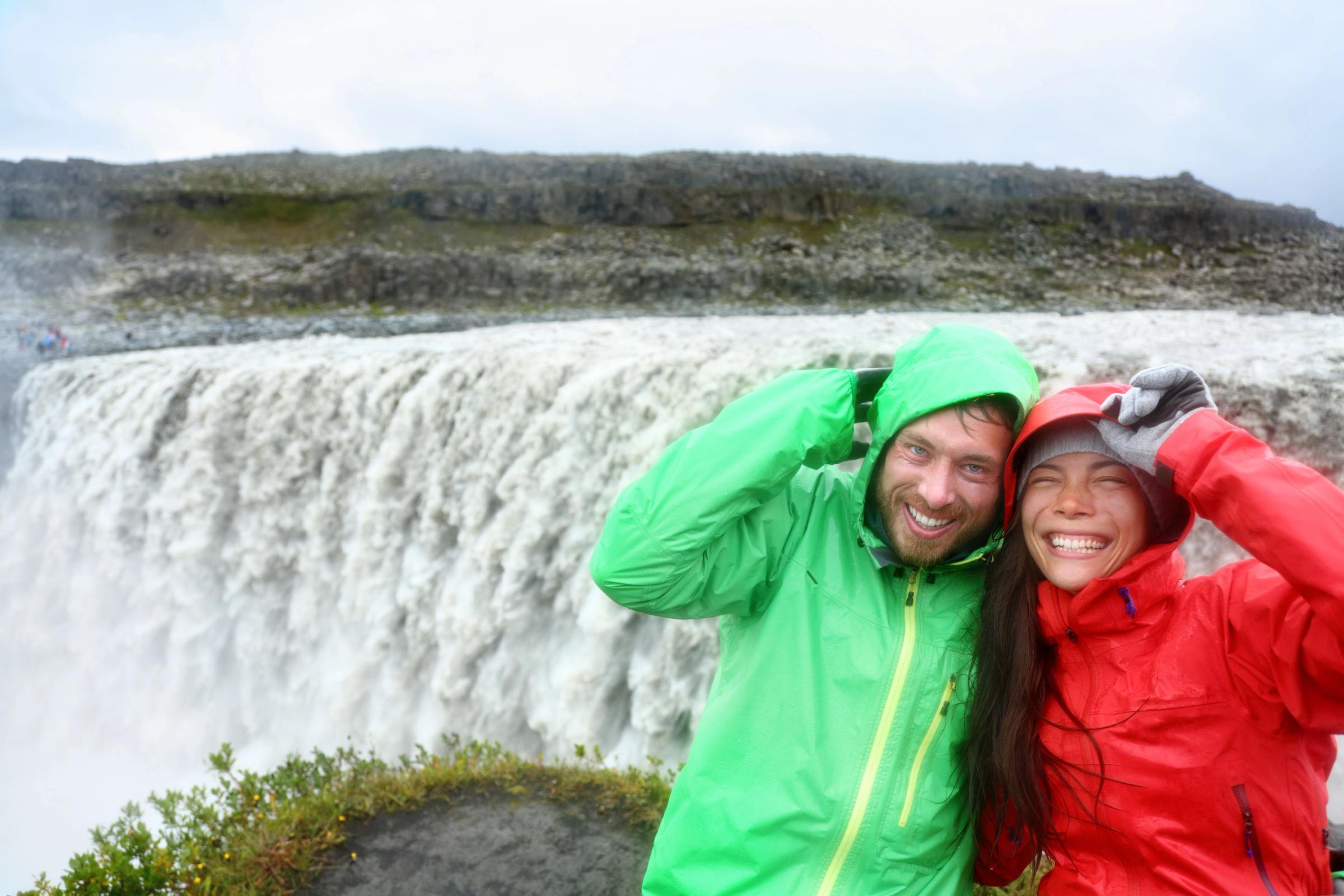 Couple having fun at Detifoss Waterfall in Iceland