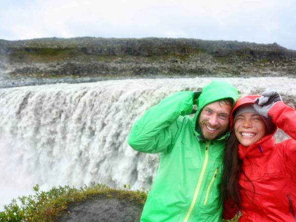 Couple having fun at Detifoss Waterfall in Iceland
