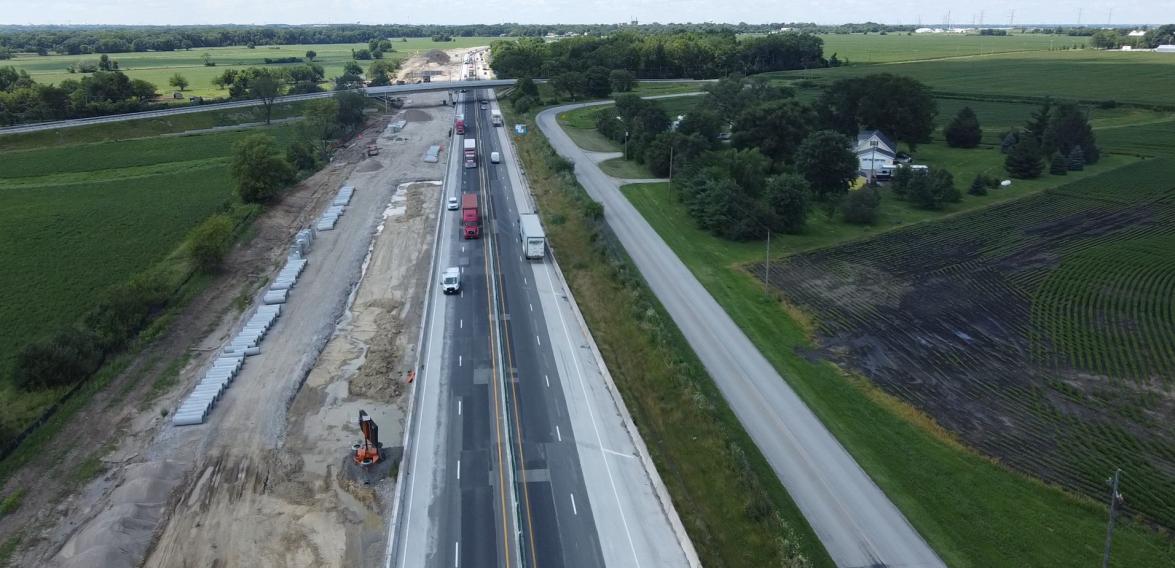 Aerial view of I-80 reconstruction between Ridge Road and River Road, with staged traffic alongside new pavement and drainage work