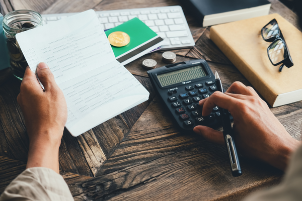 Person in front of invoices and calculator