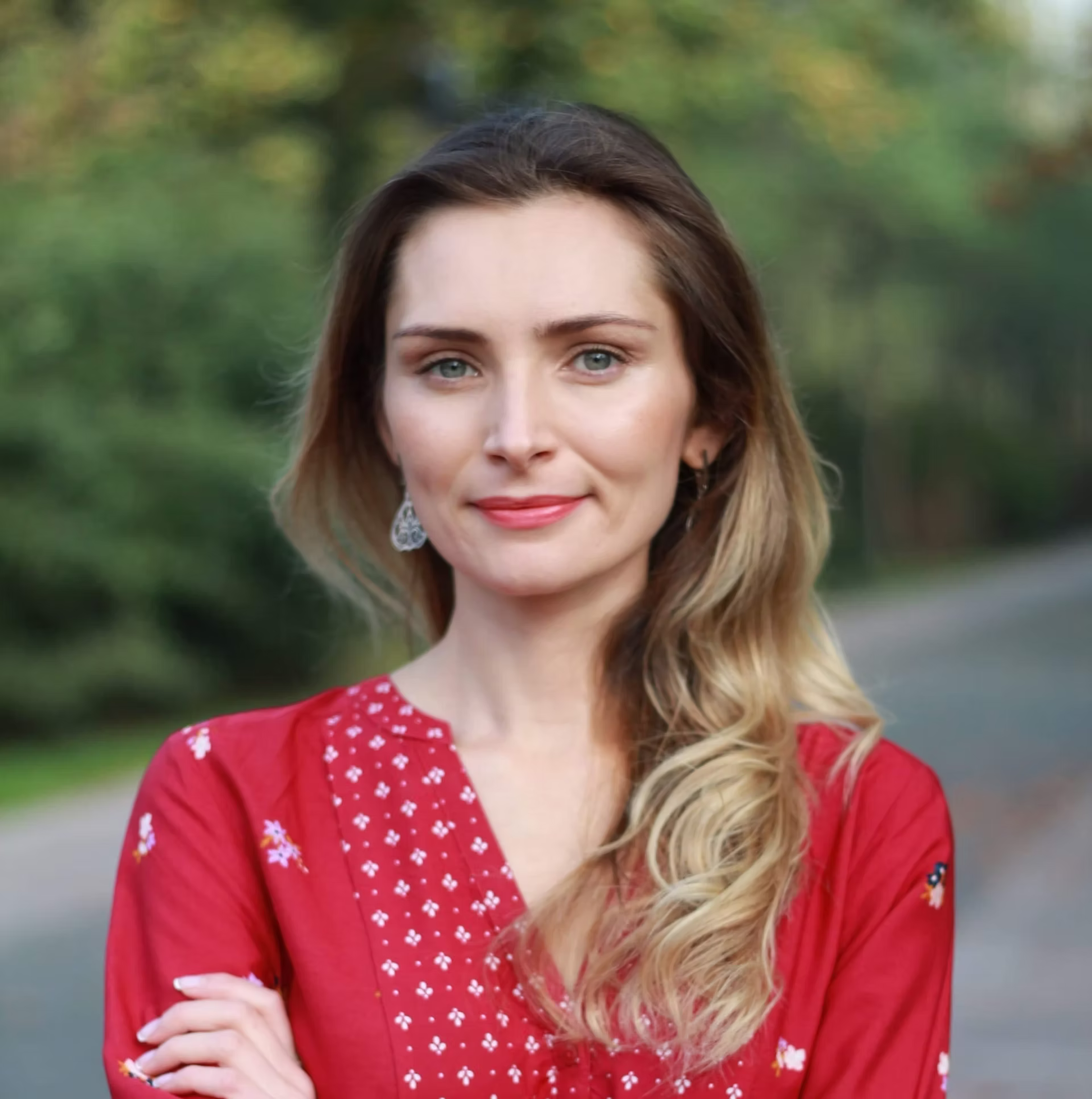 Director Maryna Tkachuk headshot in red dress