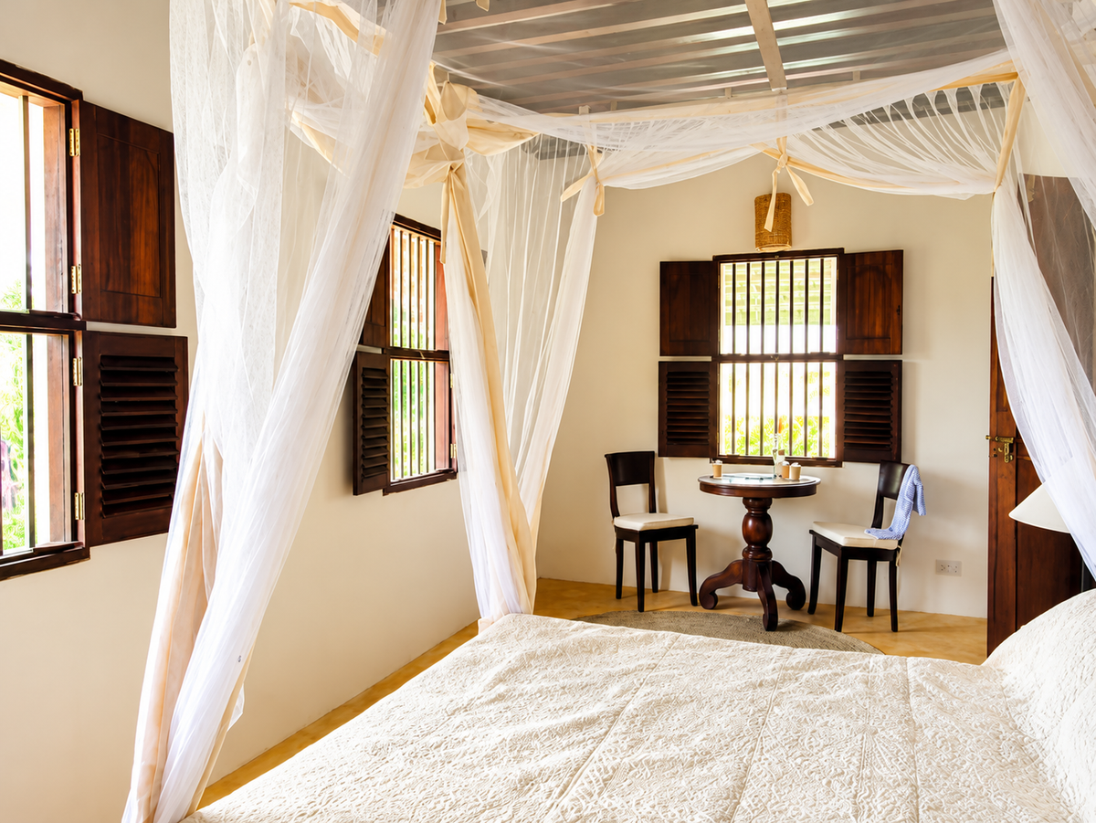 Canopy bed and a window seat with a table