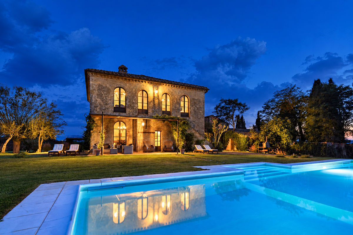 The villa and pool lit at blue hour