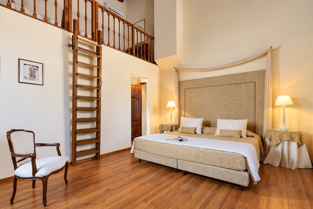 Bedroom with a timber ladder to a mezzanine