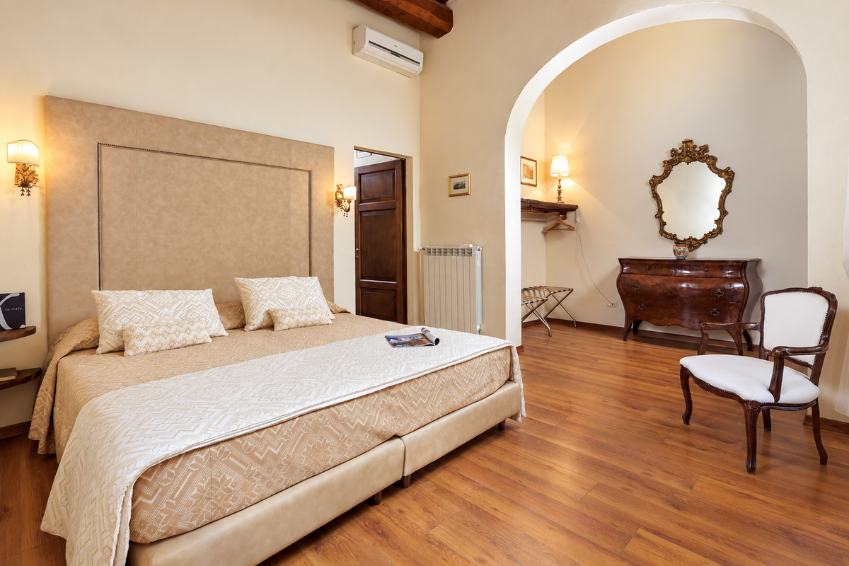 Bedroom with an arch and antique dresser