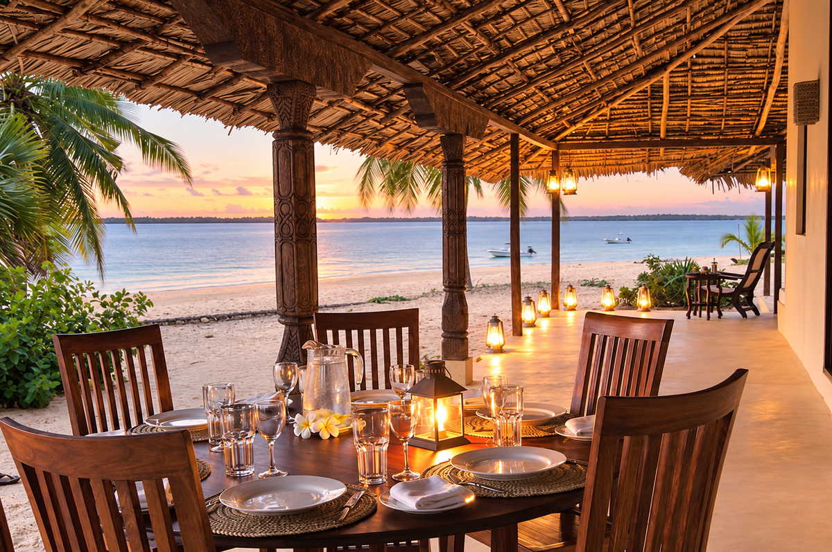 Candlelit dinner table on the veranda at sunset facing the beach