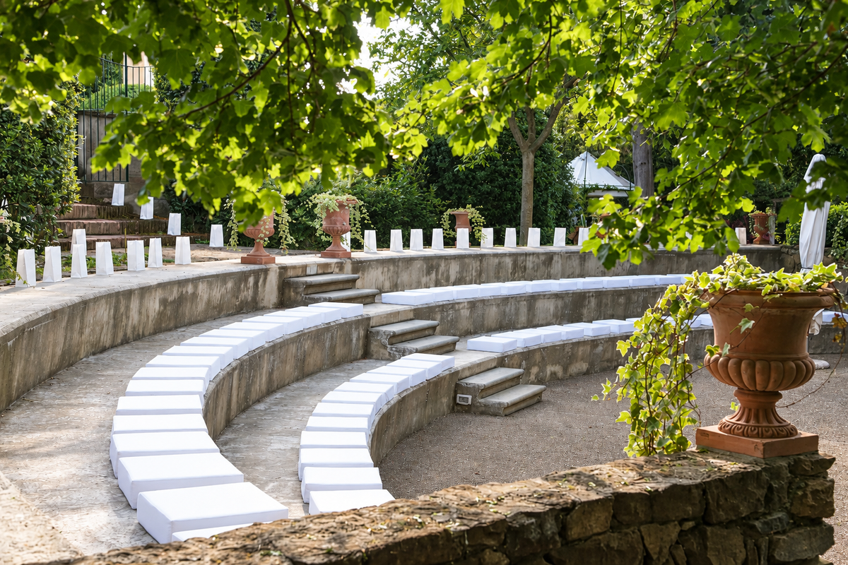 Stone amphitheatre with white seating among the trees
