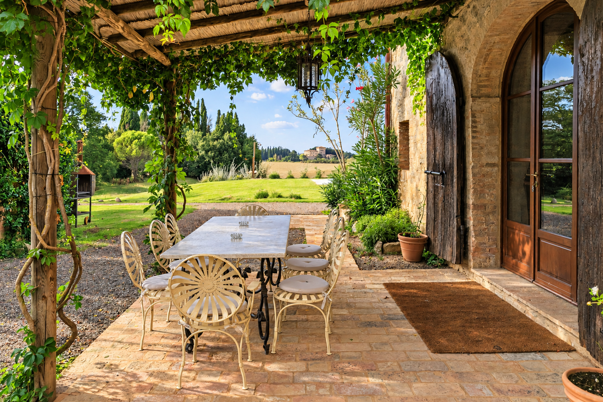 Table under a vine pergola beside the farmhouse door