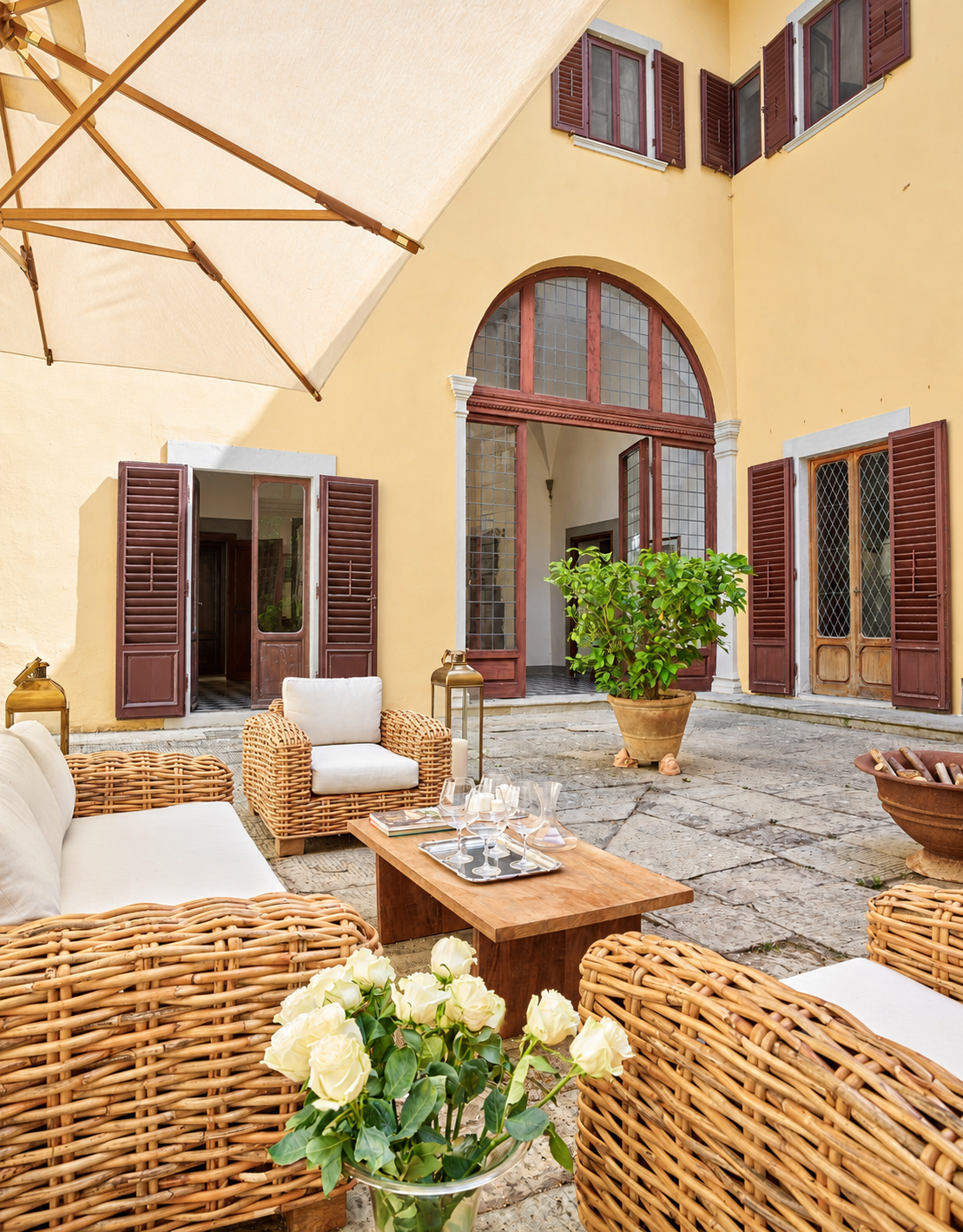 Wicker sofas in the courtyard by arched windows