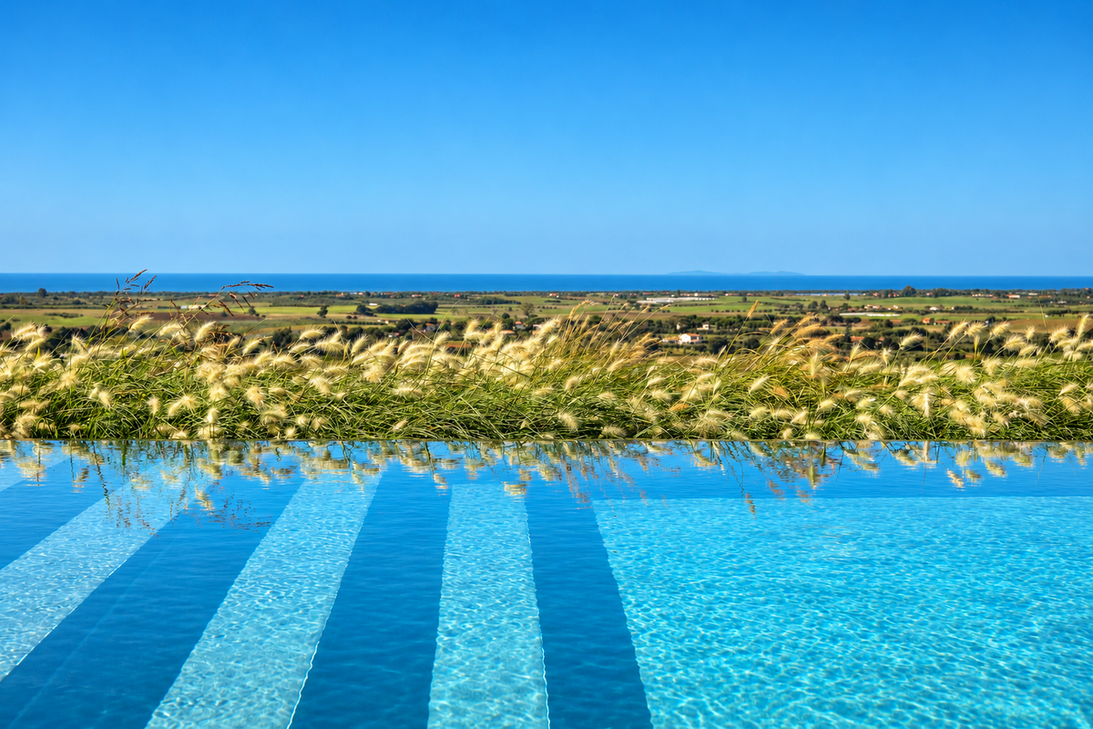 Villa Sofia's infinity pool, with the fields and the sea beyond