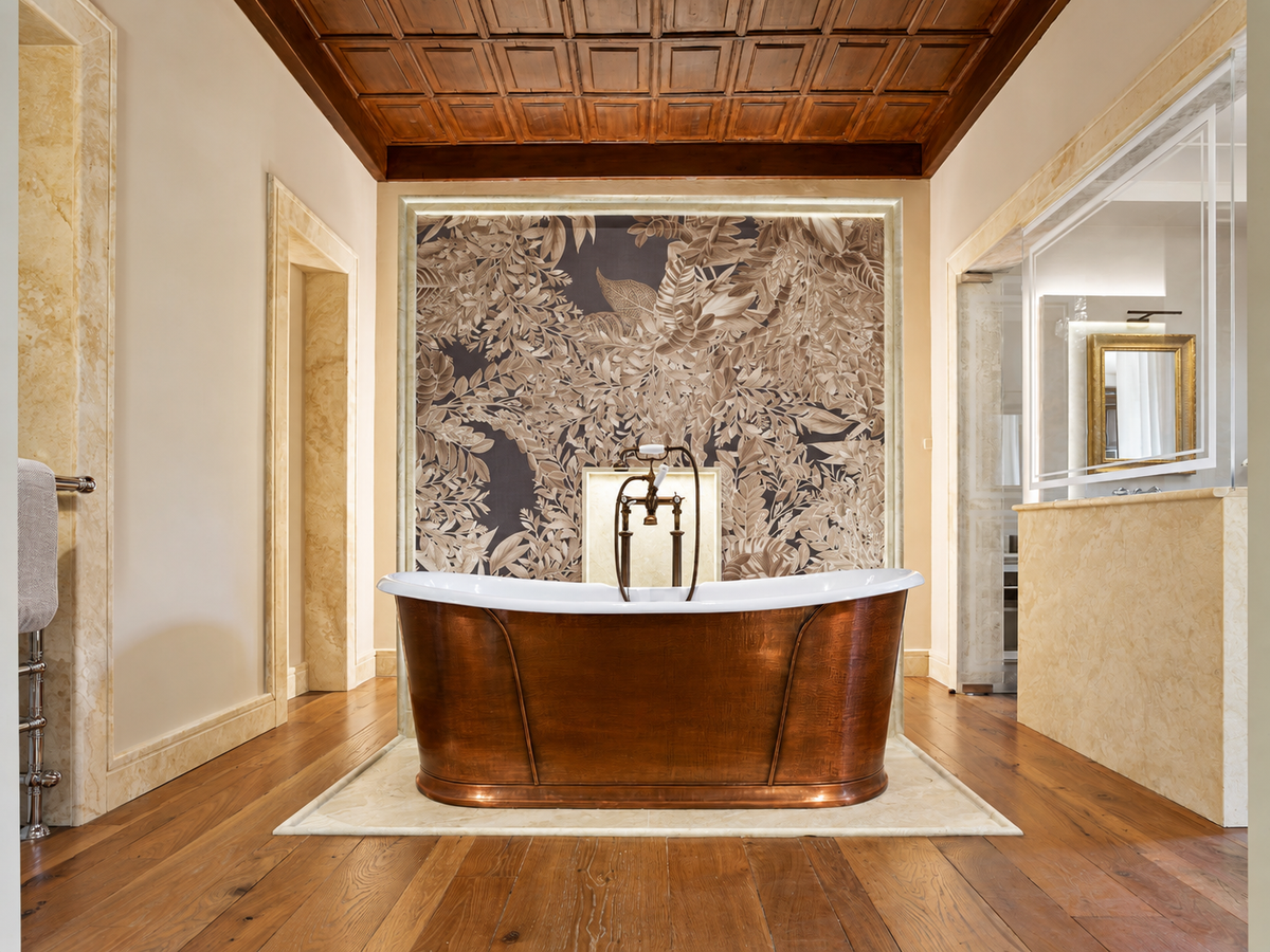 Copper bathtub under a coffered timber ceiling in the Da Vinci Suite