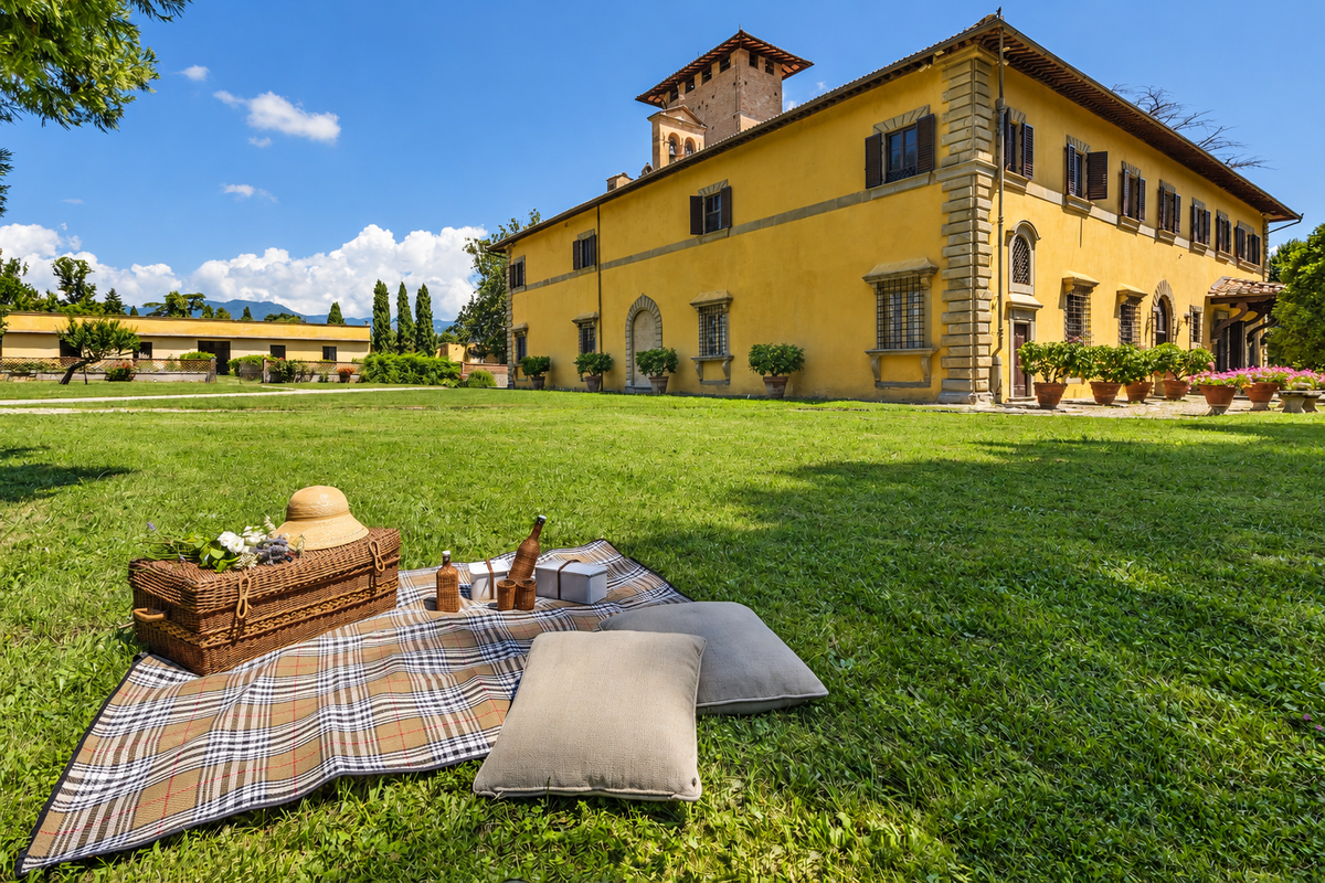 Picnic blanket and basket on the lawn before the castle