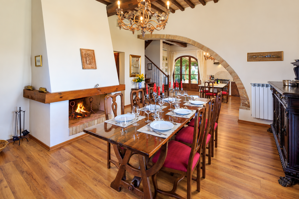 Dining room with a fireplace and long table