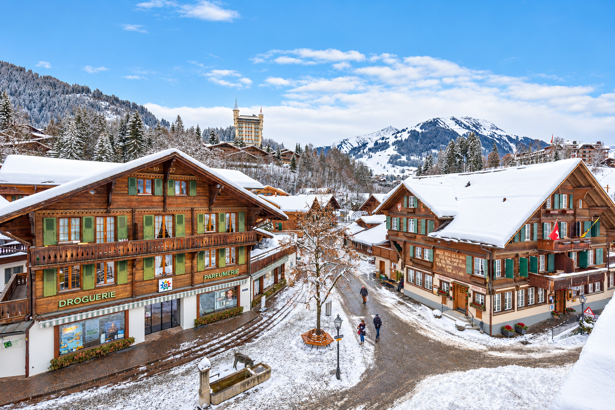 Gstaad's Promenade in the snow, with the Gstaad Palace and the mountains beyond