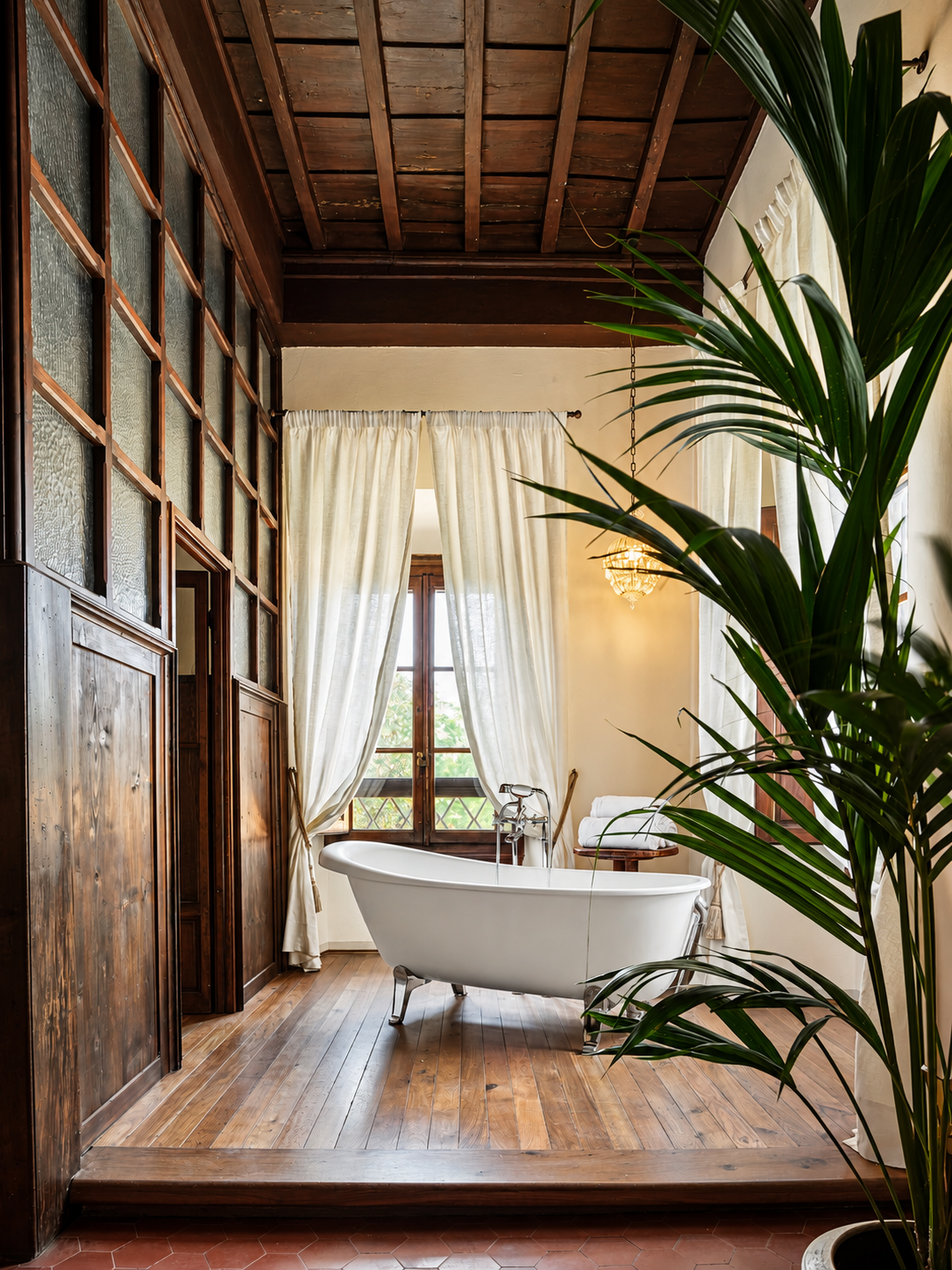 Freestanding bath by the window under a coffered ceiling