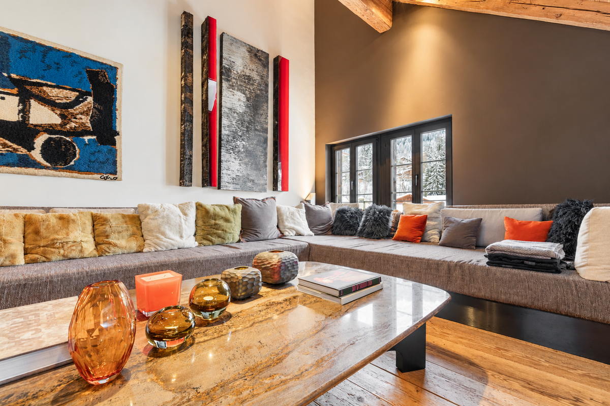 Long sofa with cushions and modern art under the roof