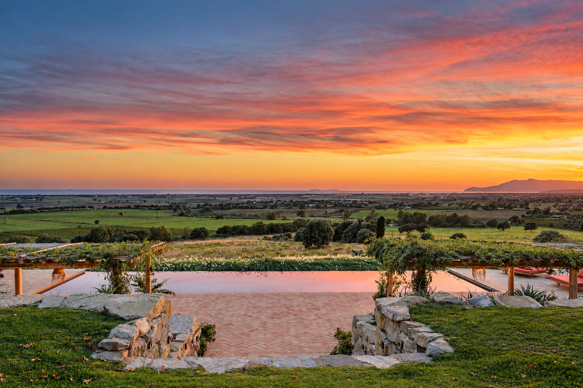Sunset over the Maremma plain and the sea, beyond the pool terrace