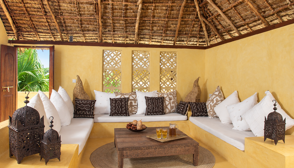 Covered lounge with white cushions and lanterns