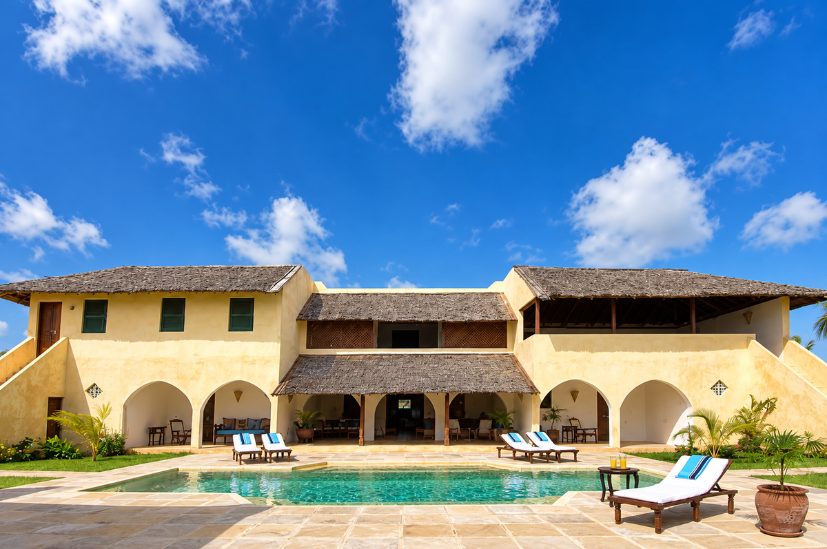 Villa with arches beside a long pool and loungers
