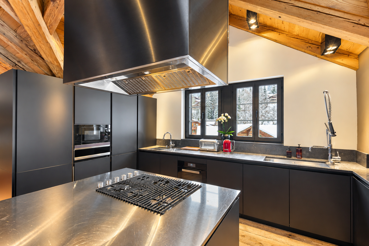 Kitchen in dark steel and timber, with a large island