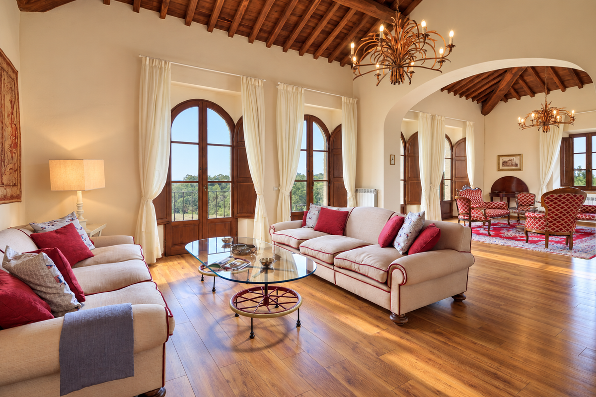 Living room with arched windows, beamed ceiling and chandelier