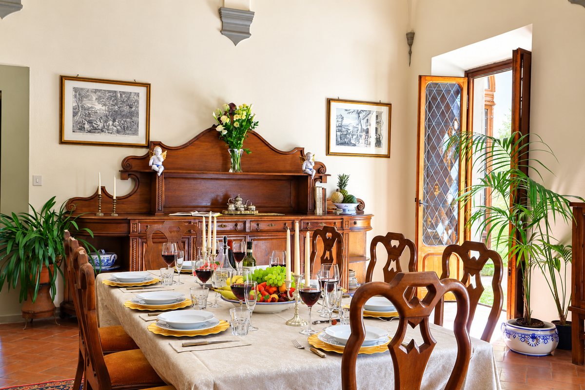 Dining room with a carved sideboard and a table laid for dinner