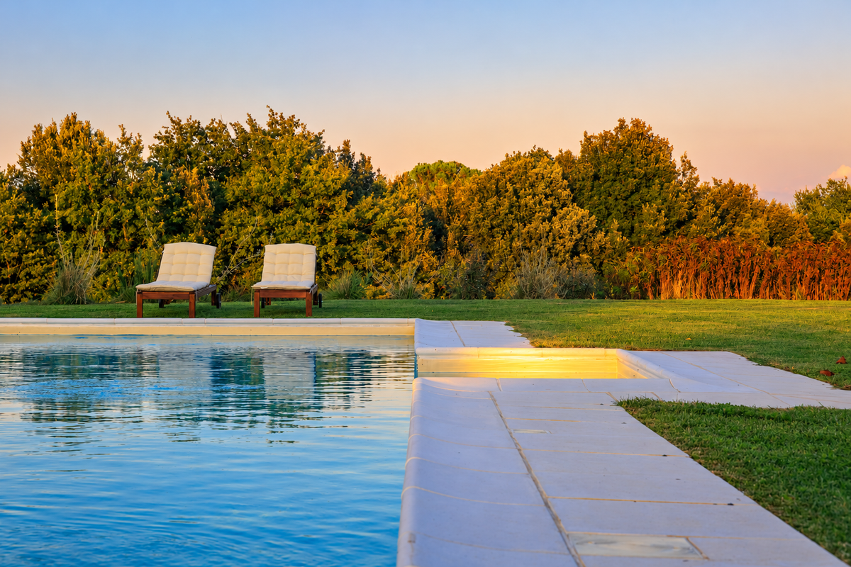 Pool at sunset with two loungers