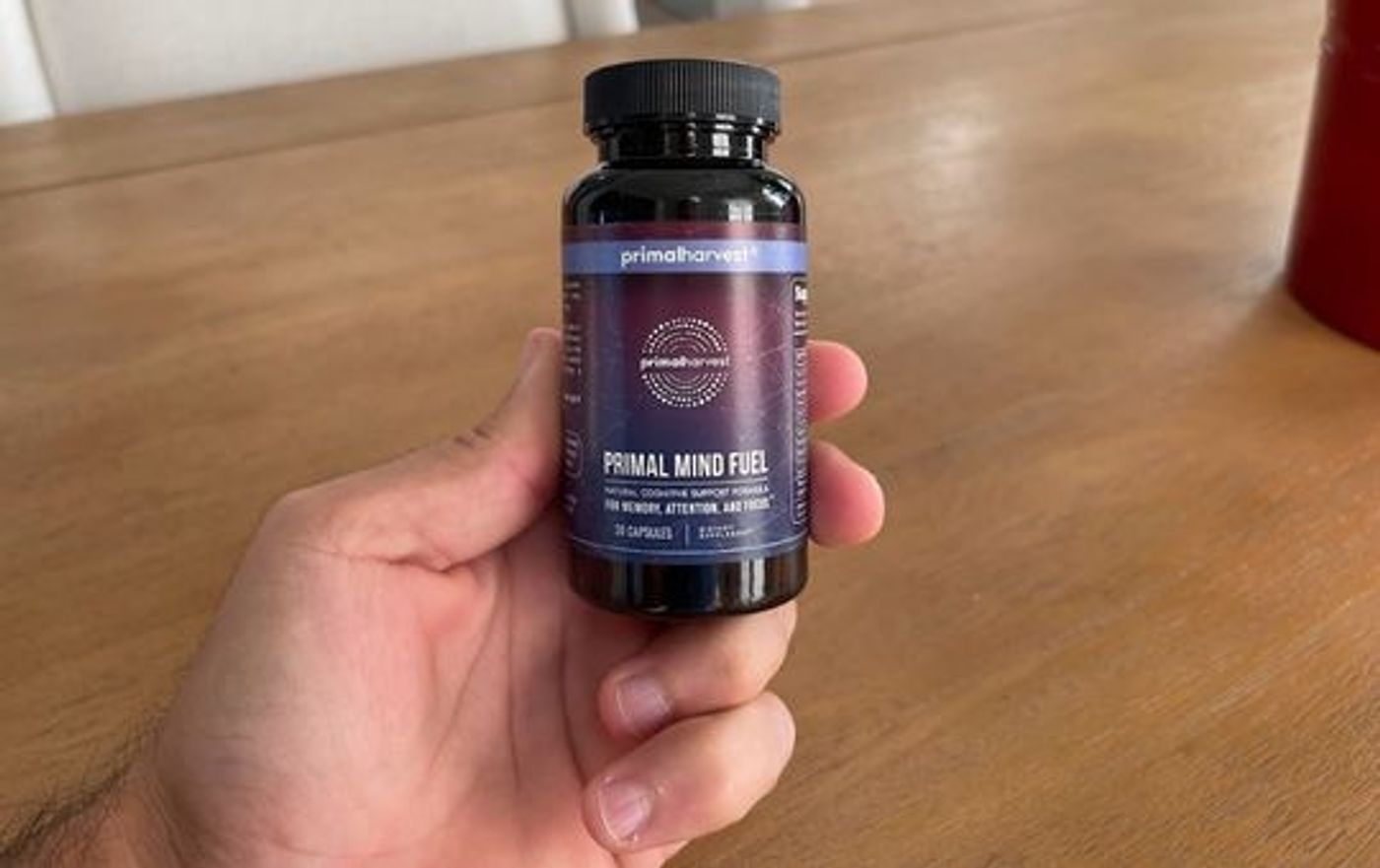 Primal mind fuel supplements in a persons hand