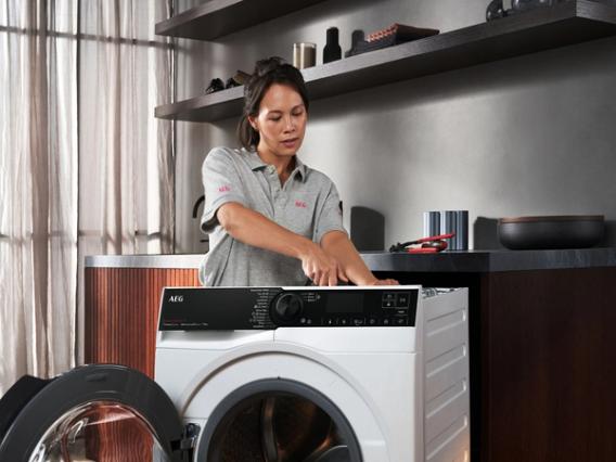 Service technician repairing washing machine