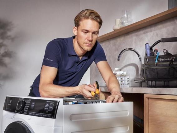 Technician repairing washing machine