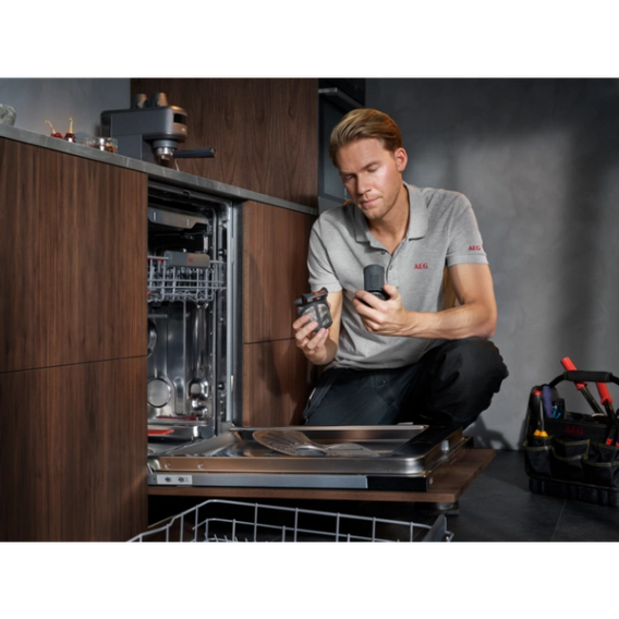 technician repairing AEG dishwasher