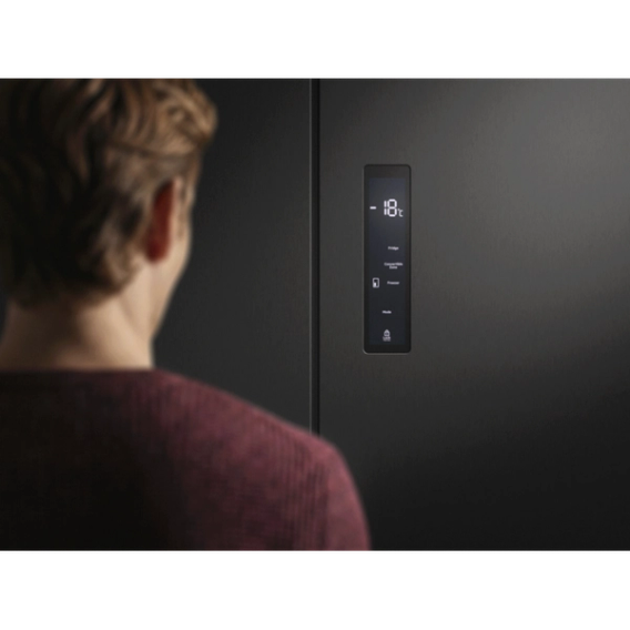 a man setting a freezer temperature