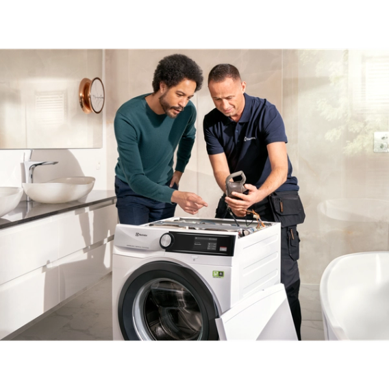 Service technician repairing washing machine