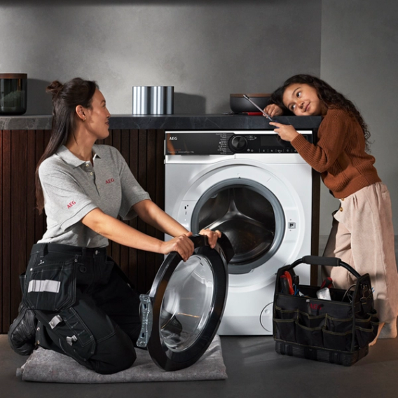 technician fixing an AEG tumble dryer