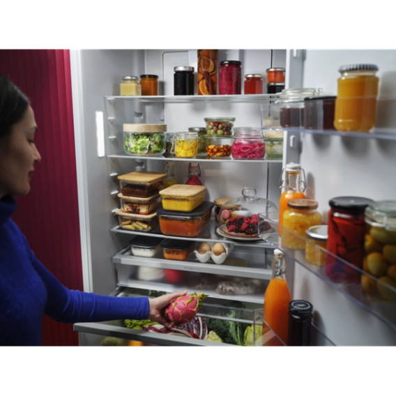 a woman opening the fridge