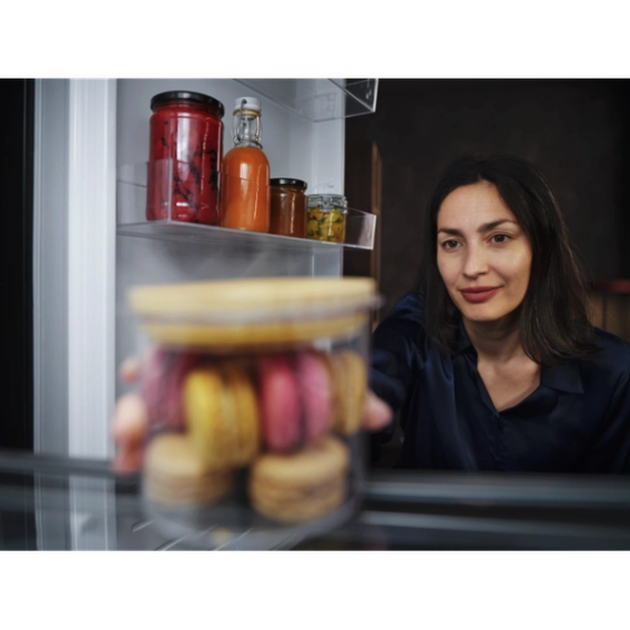 a woman opening the fridge