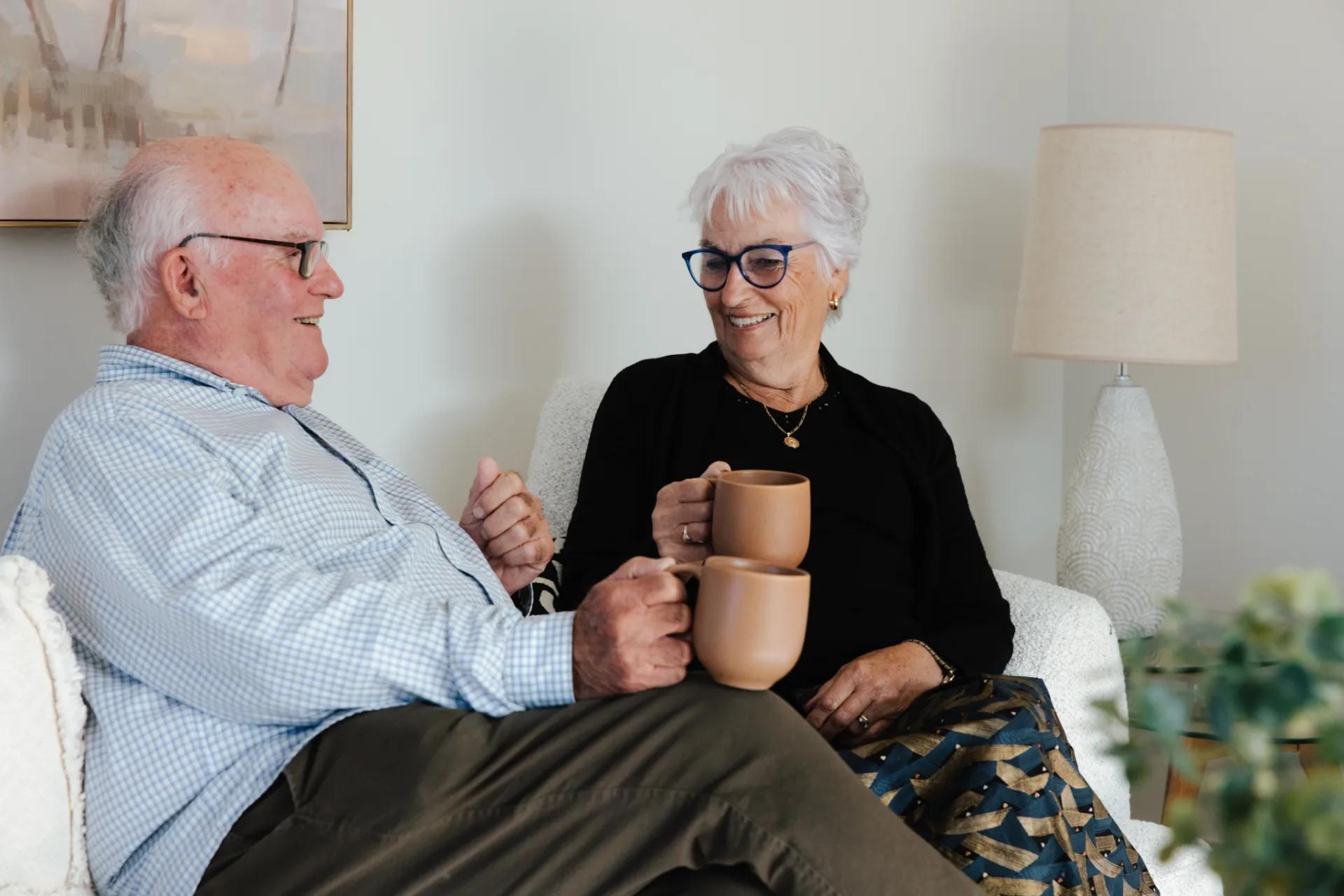 Ted Property Management Tenants sitting on a couch and drinking Tea in their Christchurch rental property